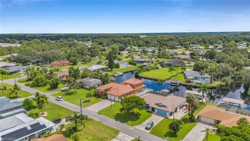 Aerial perspective of suburban area featuring a nearby body of water