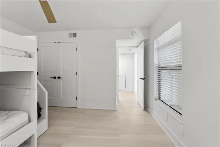 Unfurnished bedroom with a closet and ceiling fan
