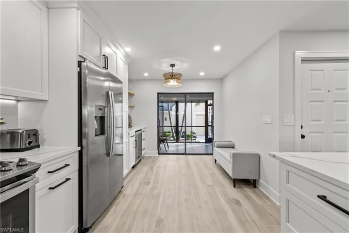 Kitchen with white cabinetry, stainless steel appliances, and recessed lighting