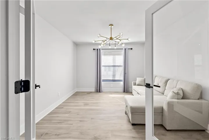 Sitting room featuring a chandelier and light wood finished floors