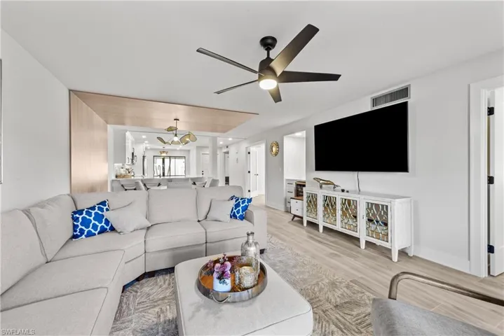 Living room featuring light wood-type flooring and a ceiling fan
