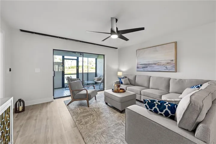 Living room featuring light wood-style floors and ceiling fan