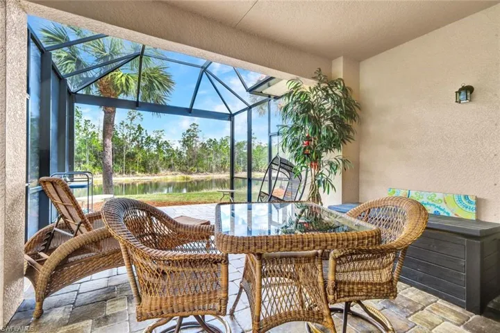 Sunroom with a patio and a water view
