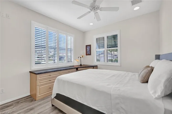 Bedroom featuring light wood-style floors, a ceiling fan, and recessed lighting