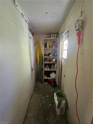 Bedroom featuring ceiling fan and unfinished concrete floors