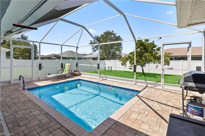 View of pool with a fenced backyard, a lanai, a sunroom, and a patio
