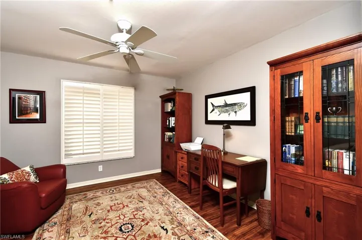 Office featuring ceiling fan and dark hardwood / wood-style flooring