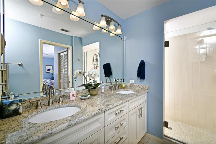 Bathroom with vanity and a shower with shower door
