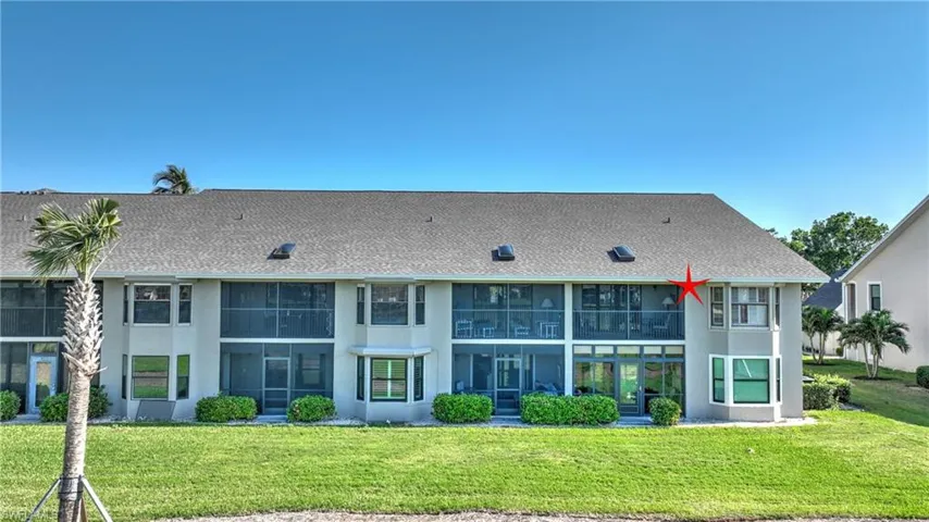 Rear view of house with a lawn