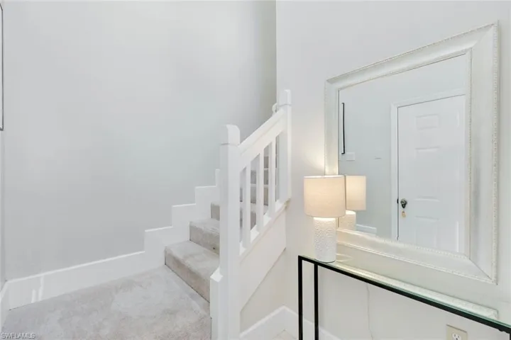 Foyer, accesses carpeted steps and garage