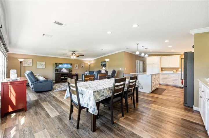 Dining room featuring crown molding, light wood finished floors, and recessed lighting