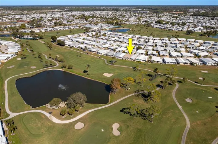 Aerial overview of property's location with nearby suburban area and a golf club