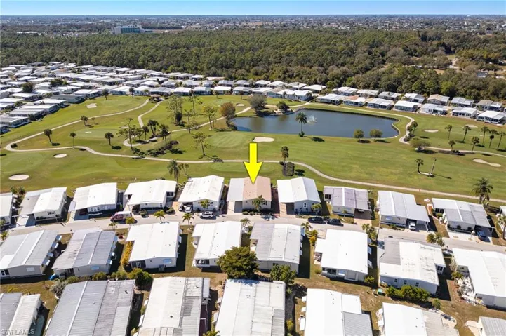 Aerial view of property's location featuring nearby suburban area and a golf club