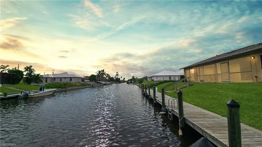 View of dock featuring a water view and a yard