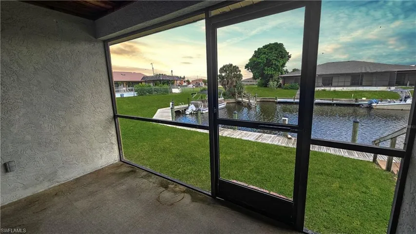 Unfurnished sunroom with a water view