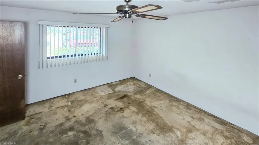 Spare room featuring carpet flooring and ceiling fan
