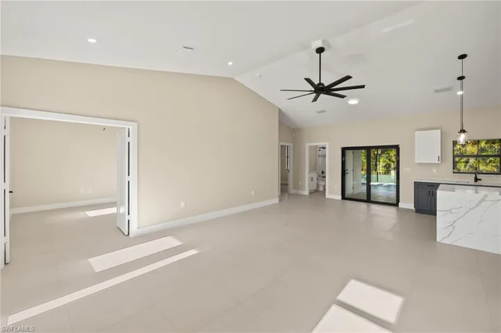 Spacious Living room, dining room and kitchen featuring a ceiling fan, 5 1/4 inch baseboards and recessed lighting