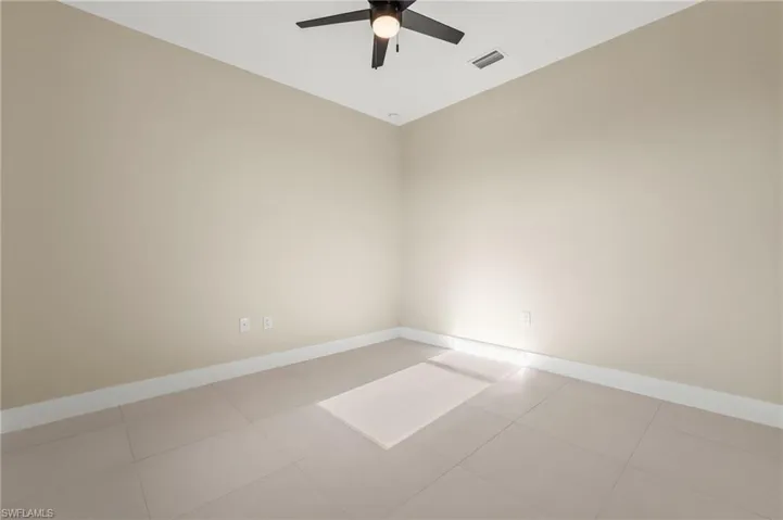 Spacious second bedroom with ceiling fan.