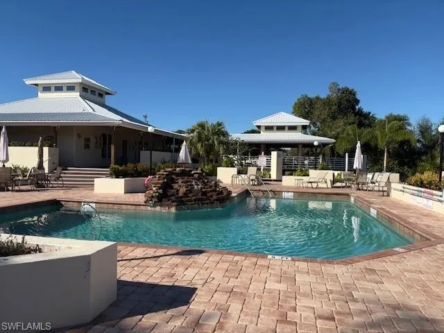 Outdoor pool with a gazebo and a patio