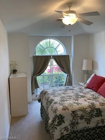 Bedroom featuring a ceiling fan and light carpet