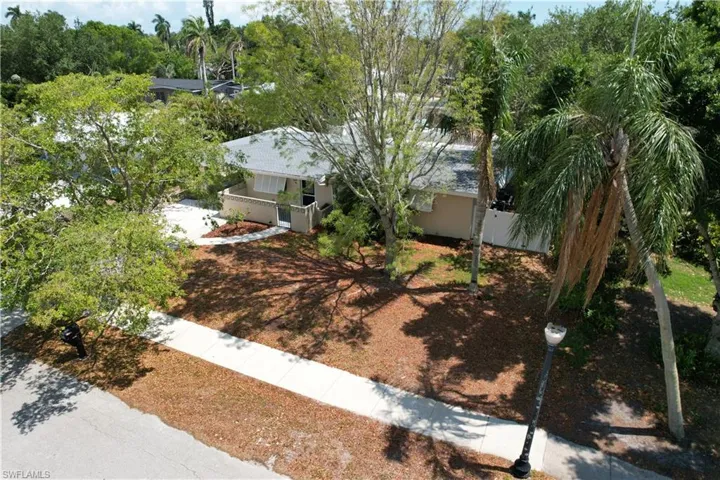 Aerial view of property's location featuring a notable bridge, a nearby body of water, and nearby suburban area