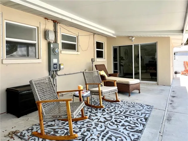 View of patio with a fire pit and fence