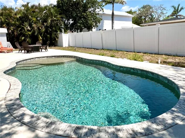 View of pool with fence and a patio