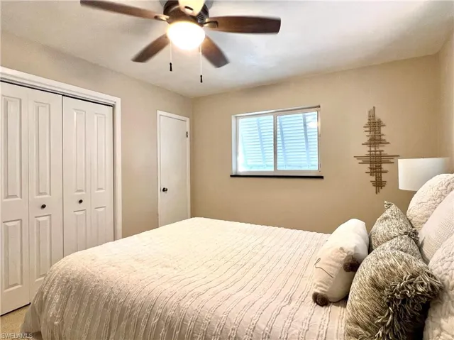 Primary Bedroom with a closet and ceiling fan