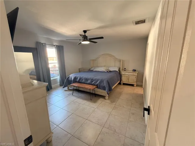 Bedroom featuring a ceiling fan and light tile patterned floors