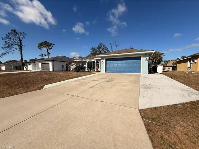 Ranch-style home with driveway and a garage