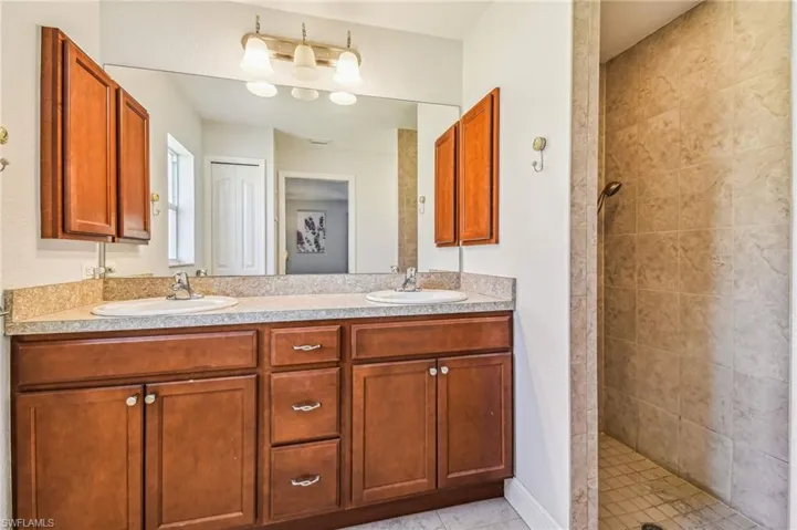 Bathroom with double vanity and a walk in shower