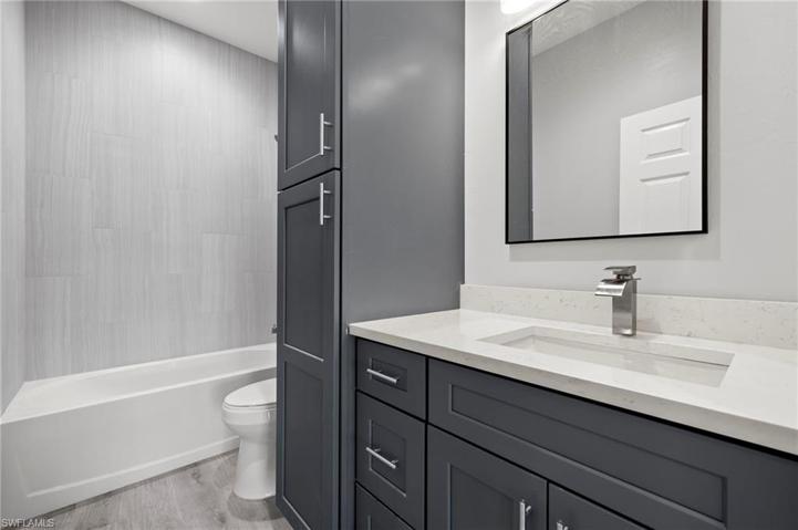 Guest Bathroom with tile surround, upgraded, built in Linen Closet/Cabinetry