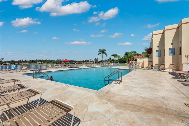 Expansive outdoor swimming pool area with plenty of lounging space