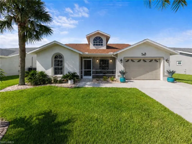Exterior featuring a stucco finish, arched windows, and a screened front entry