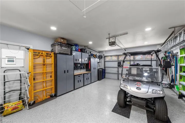 Spacious 1.5 car garage featuring an epoxy-coated concrete floor