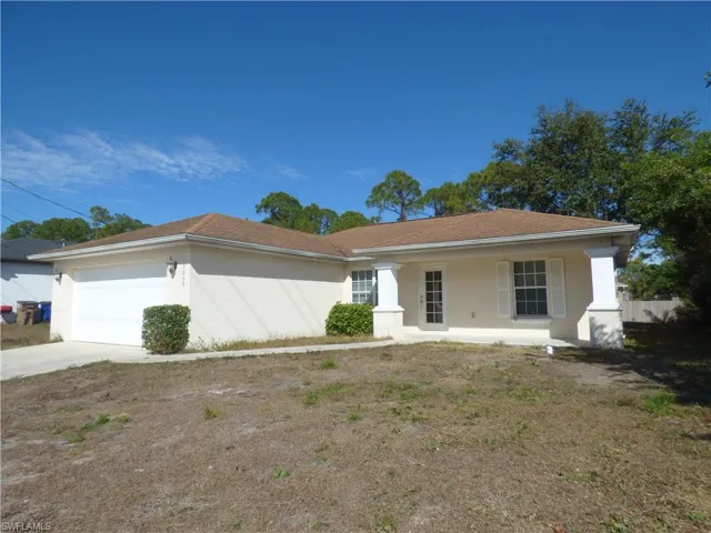 Single story home with stucco siding, driveway, an attached garage, and a porch