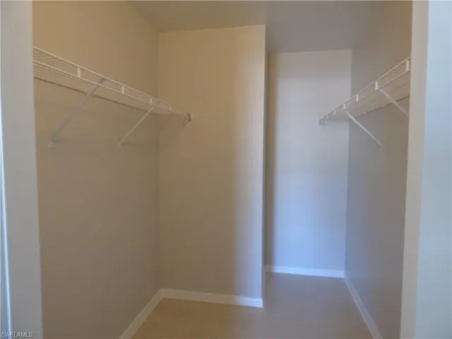 View of walk in closet in master bedroom