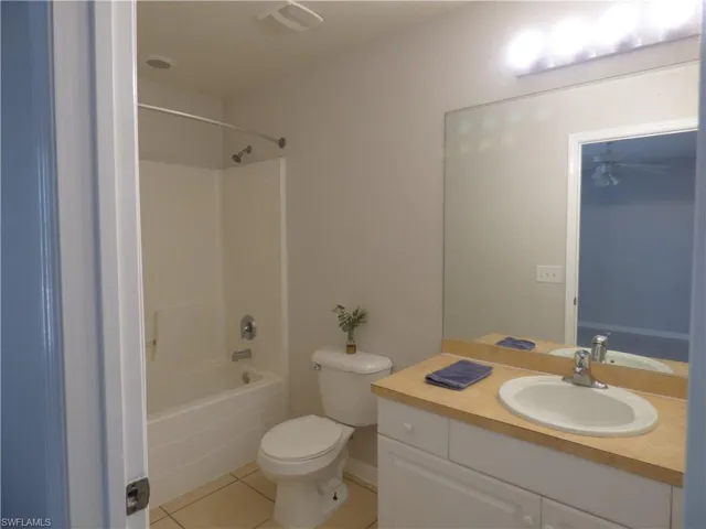 Master bathroom featuring shower / bath combination, vanity, and light tile patterned floors