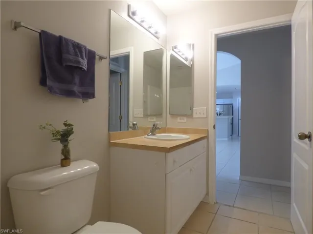 Full guest bath featuring vanity and light tile patterned flooring