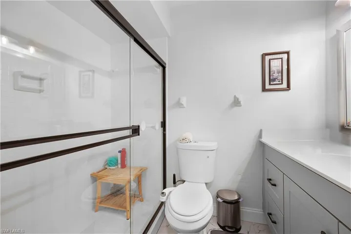 Full bath with vanity and a stall shower