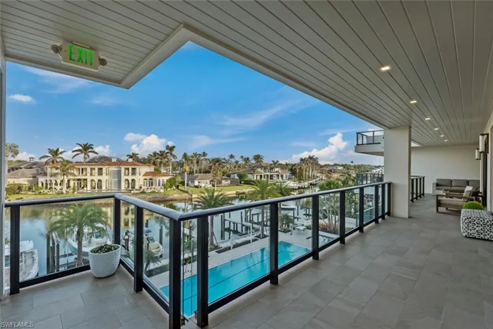 Balcony featuring view of pool area
