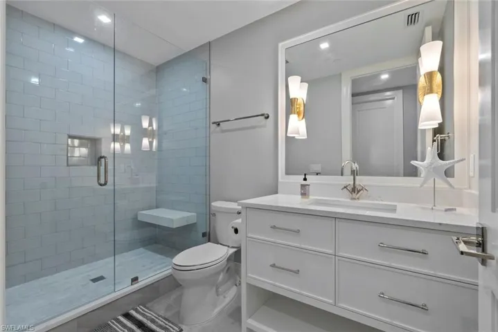 Full bath with vanity, a stall shower, and recessed lighting