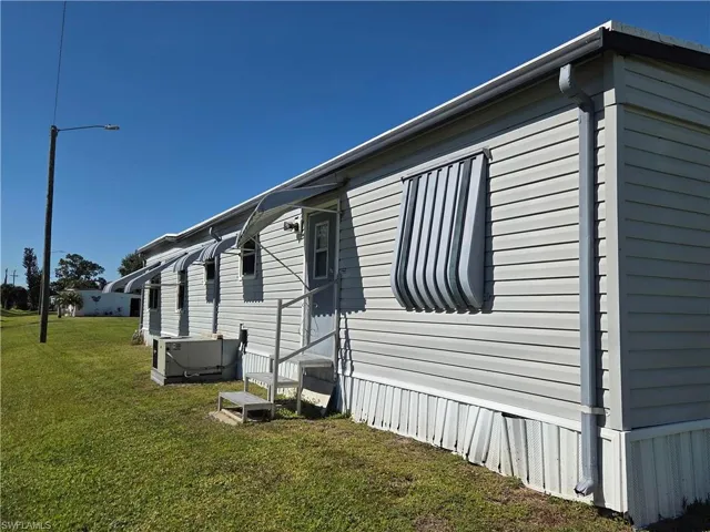 Awnings all around for weather protection & energy savings. There is even a back door for convenient access.