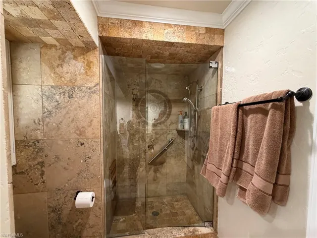 Full bath with a large walk in shower and grab bars for safety