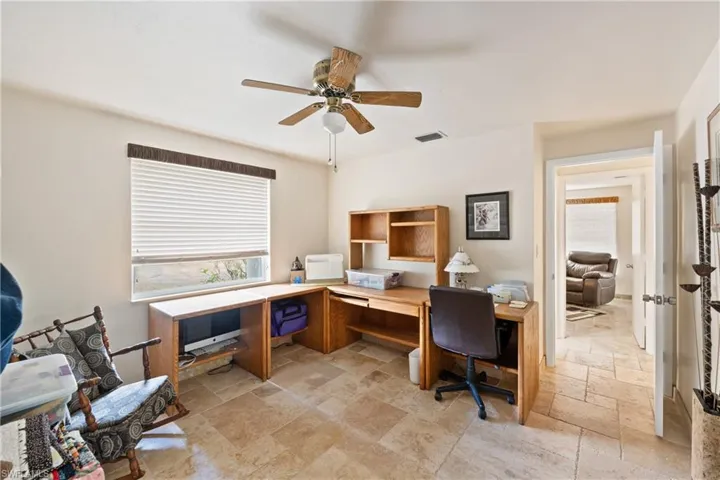 Bedroom/ Office area featuring stone tile floors, and large closet