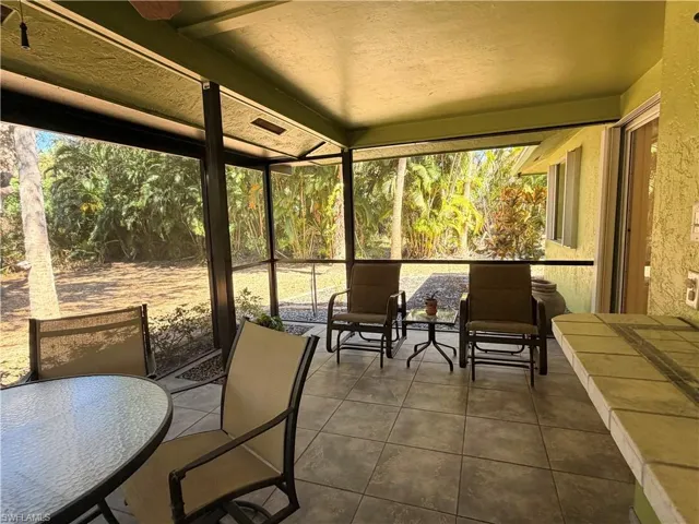 Spacious and secluded Sunroom featuring outdoor dining area