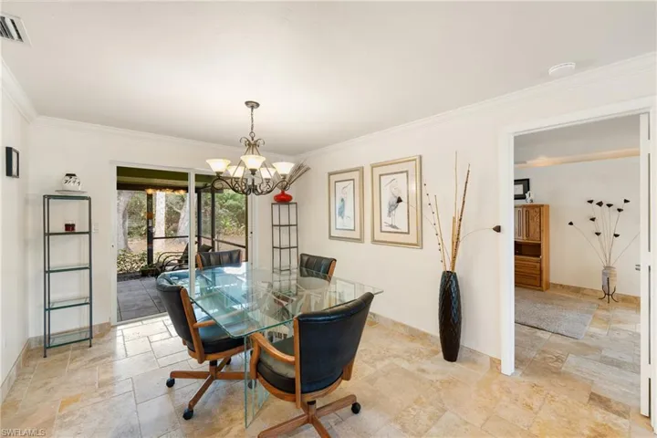 Dining area, chandelier, and crown molding