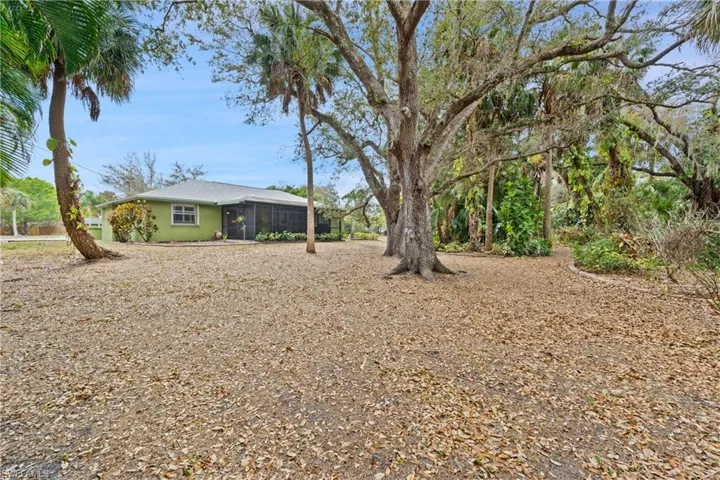 View of large yard with a sunroom