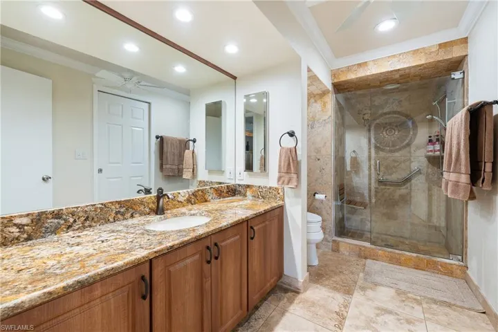 spacious Full bathroom featuring , crown molding,  stall shower, double vanity, and recessed lighting