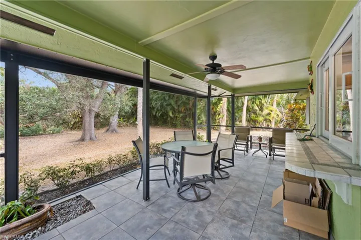 Ultimate Privacy Lanai featuring outdoor dining area and ceiling fan